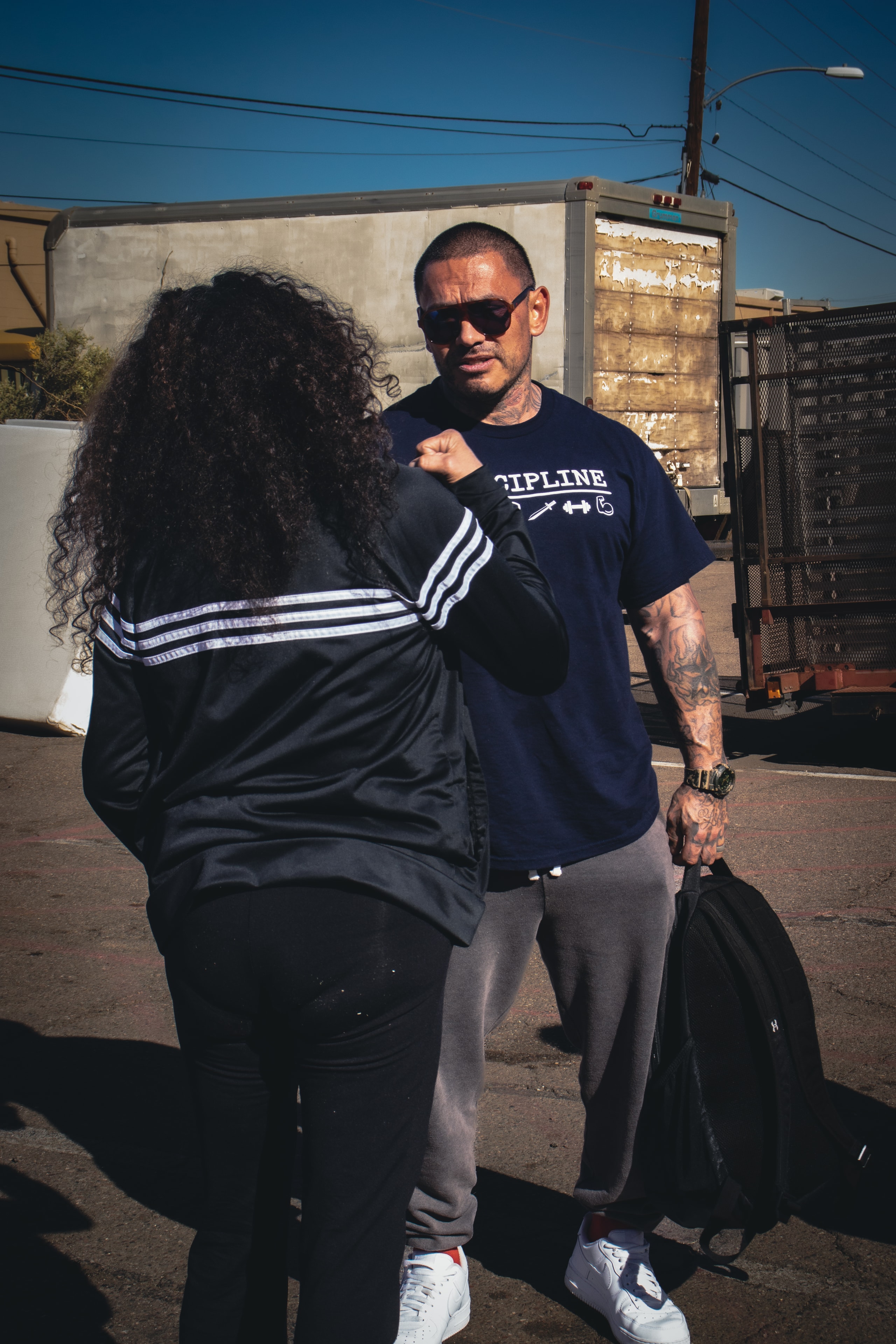 Julio fist-bumping a community member at an outreach event